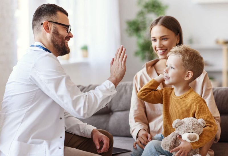 doctor and mother with child in family clinic